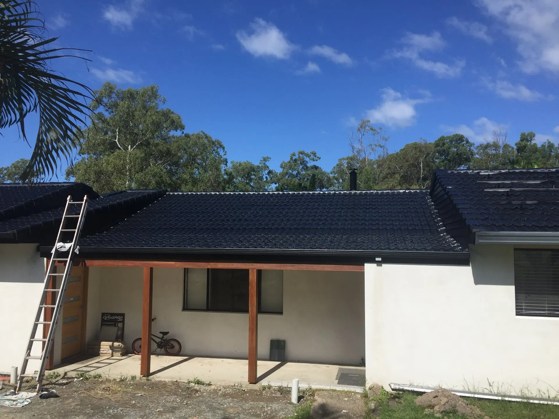 Single-storey home with a newly coated charcoal tiled roof